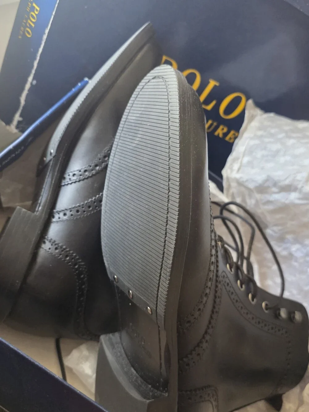 Polo Ralph Lauren lace-up leather boots feature classic wingtip brogue detailing